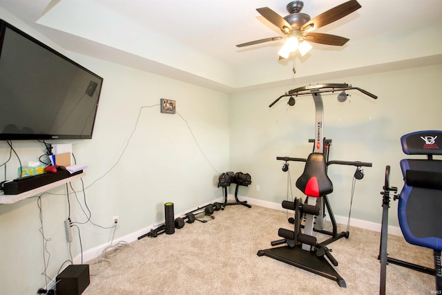 workout area with ceiling fan and light carpet