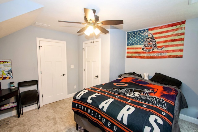 bedroom with ceiling fan, light carpet, and vaulted ceiling