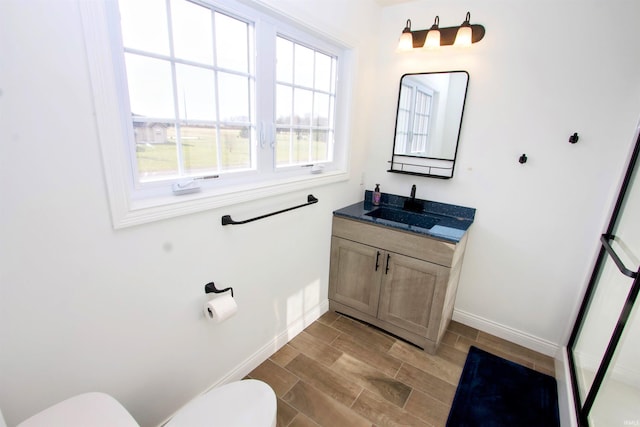 bathroom with vanity, hardwood / wood-style flooring, and toilet