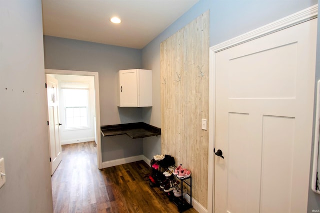 clothes washing area with dark hardwood / wood-style flooring