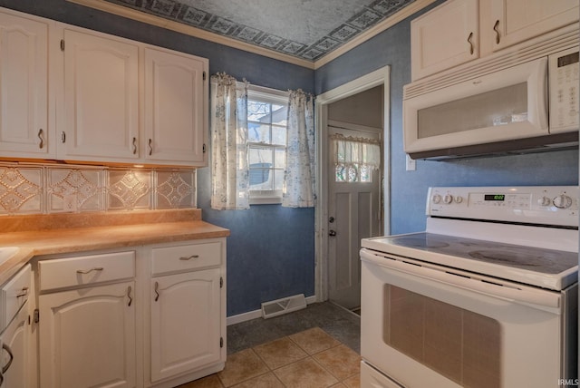 kitchen featuring white cabinetry, backsplash, crown molding, white appliances, and light tile patterned floors