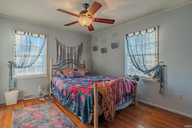 bedroom with hardwood / wood-style floors, ceiling fan, and ornamental molding