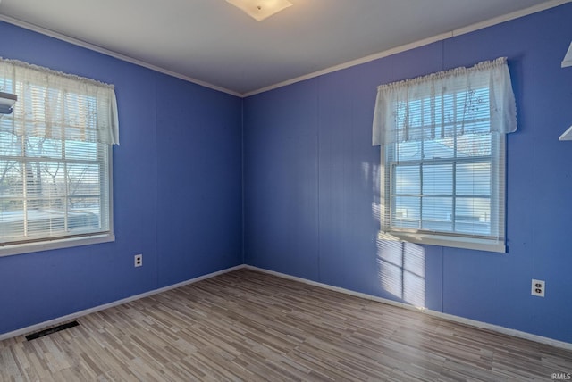 unfurnished room with wood-type flooring and ornamental molding