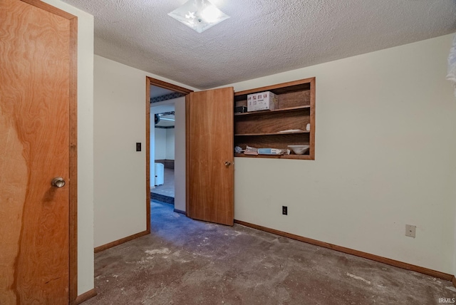 unfurnished room featuring a textured ceiling