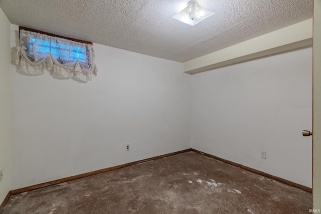 unfurnished room with a textured ceiling