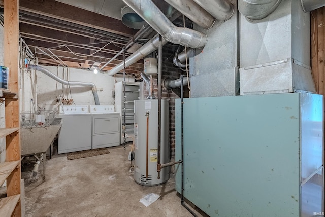 basement with washing machine and clothes dryer and gas water heater