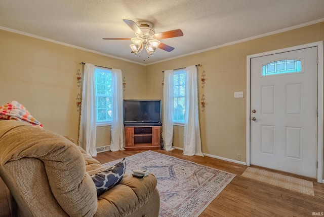 living room with ceiling fan, light hardwood / wood-style floors, and ornamental molding