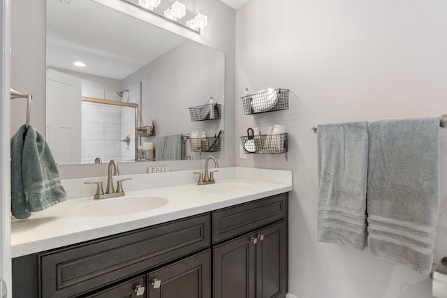 bathroom featuring vanity and a shower with shower door