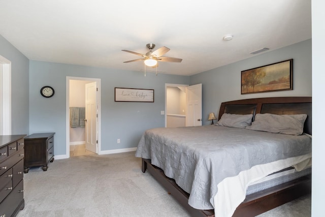 carpeted bedroom featuring connected bathroom and ceiling fan