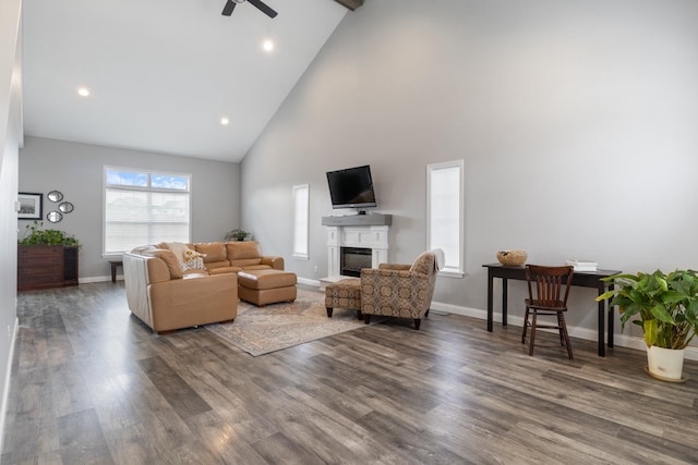 living room with ceiling fan, wood-type flooring, and high vaulted ceiling