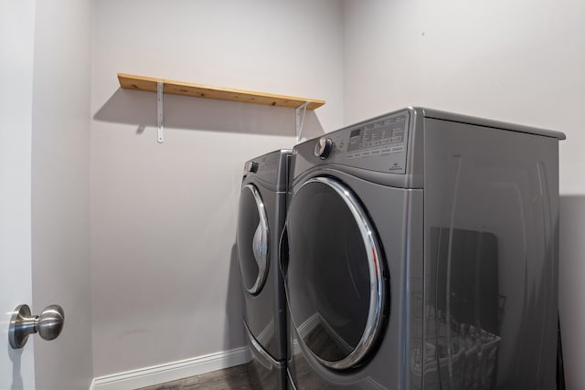 laundry area featuring washer and clothes dryer and hardwood / wood-style flooring