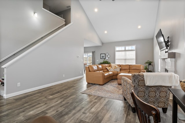 living room with dark hardwood / wood-style floors and high vaulted ceiling