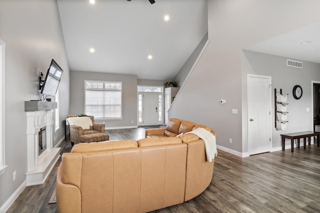 living room with dark hardwood / wood-style floors and high vaulted ceiling