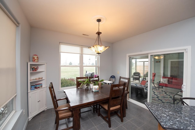 dining area with dark tile patterned floors