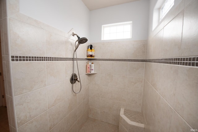 bathroom featuring a tile shower