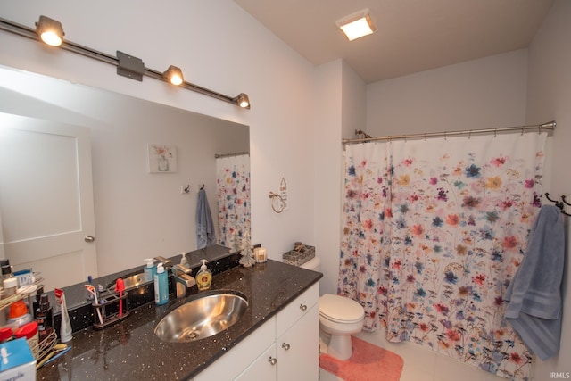 bathroom with vanity, tile patterned flooring, and toilet