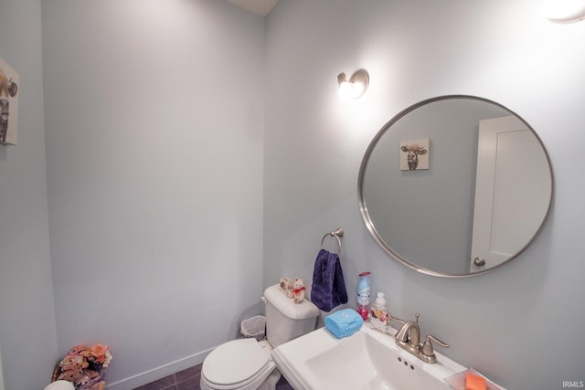 bathroom featuring tile patterned flooring, sink, and toilet