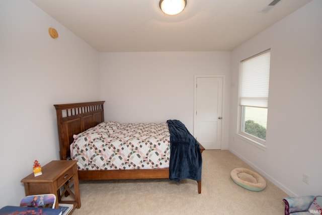 bedroom featuring light colored carpet