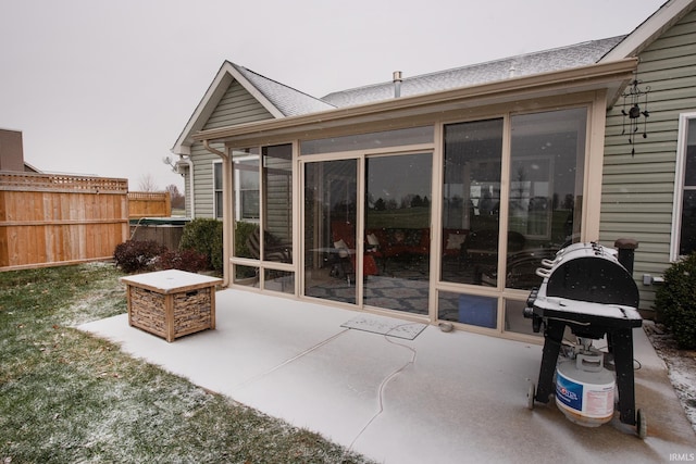 view of patio with grilling area and a sunroom