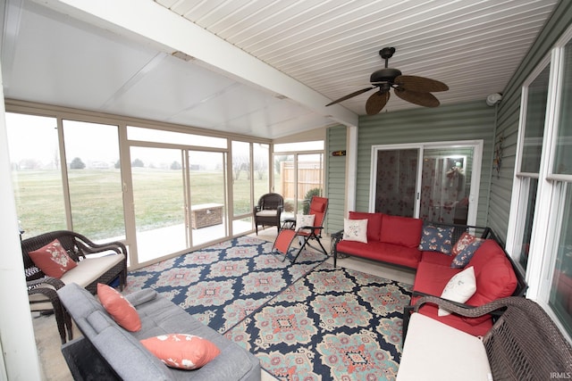 sunroom featuring vaulted ceiling with beams, a rural view, and ceiling fan