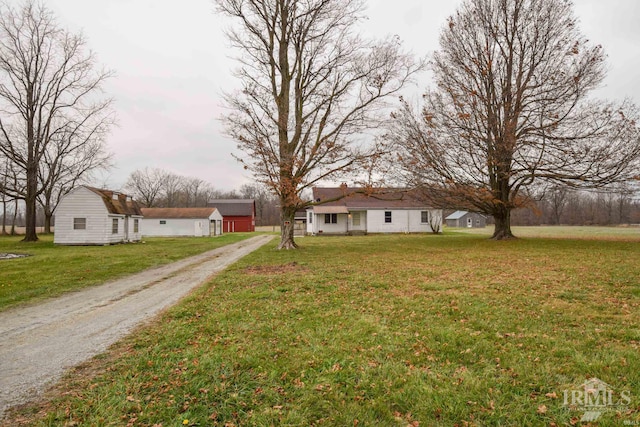 view of front facade featuring an outbuilding and a front lawn