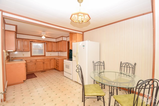 kitchen with backsplash, ceiling fan with notable chandelier, white appliances, and ornamental molding