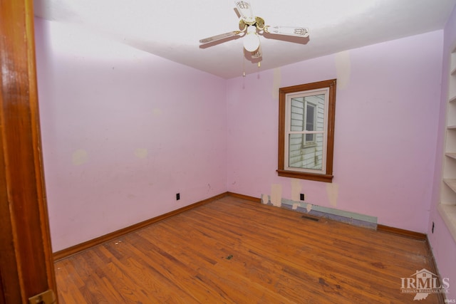 empty room with hardwood / wood-style flooring and ceiling fan