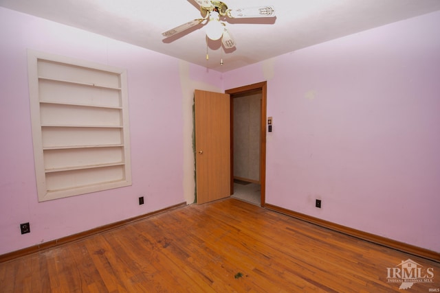 empty room with ceiling fan and wood-type flooring