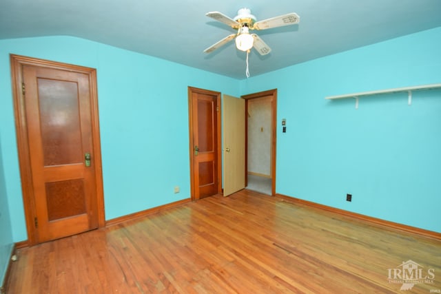 unfurnished bedroom featuring light hardwood / wood-style flooring, ceiling fan, and lofted ceiling