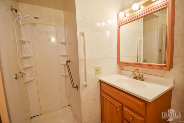 bathroom featuring vanity, tile walls, and shower / washtub combination