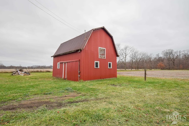 view of outbuilding featuring a lawn