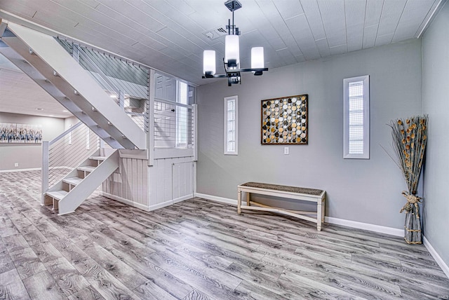 foyer entrance featuring a chandelier and hardwood / wood-style floors