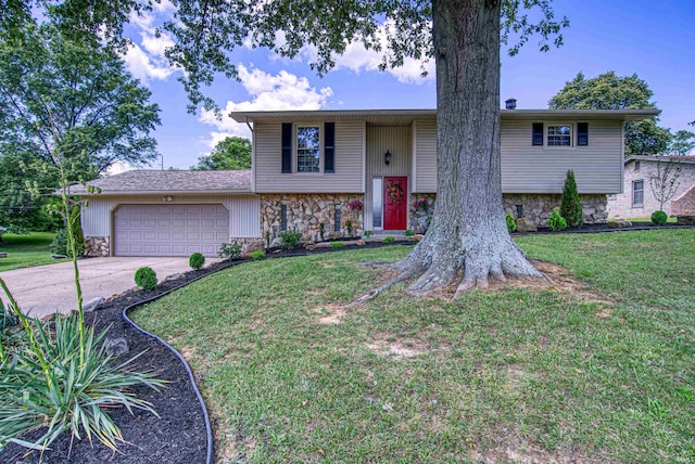 raised ranch with a front yard and a garage