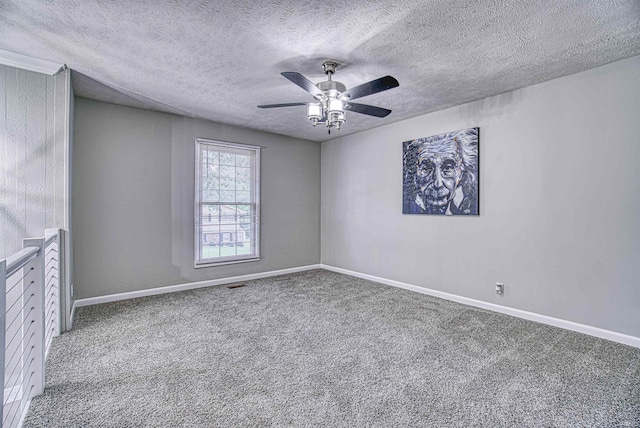 carpeted empty room featuring a textured ceiling and ceiling fan