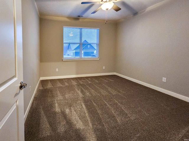 unfurnished room with dark carpet and ceiling fan