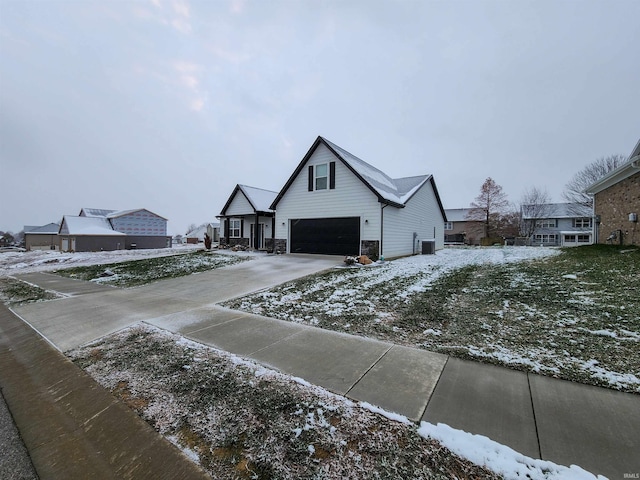 view of front of property with a garage and central AC unit