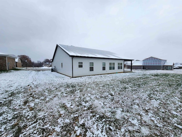 view of snow covered rear of property