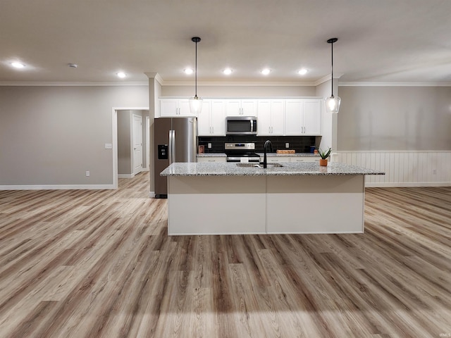 kitchen featuring white cabinetry, light stone countertops, stainless steel appliances, and light wood-type flooring