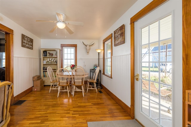 dining space featuring ceiling fan and hardwood / wood-style flooring