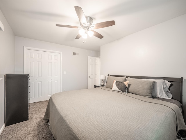 carpeted bedroom featuring a closet and ceiling fan