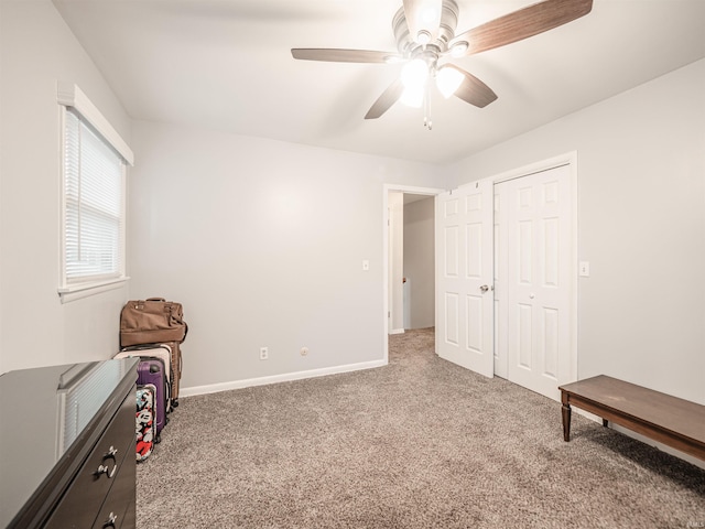 interior space featuring carpet flooring and ceiling fan