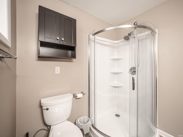 bathroom featuring toilet and an enclosed shower