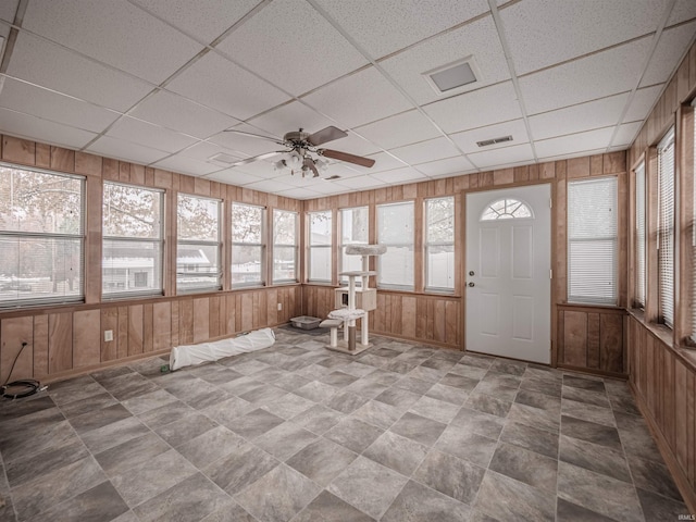 unfurnished sunroom with a paneled ceiling and ceiling fan