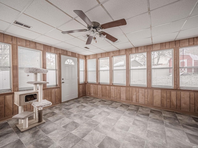 unfurnished sunroom featuring a paneled ceiling and ceiling fan