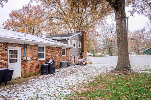 snow covered property featuring cooling unit