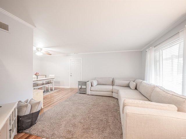 living room with crown molding, ceiling fan, and wood-type flooring