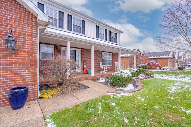 view of front of property with a porch and a front lawn