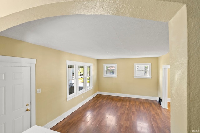 entrance foyer featuring dark hardwood / wood-style floors, a textured ceiling, and a wealth of natural light