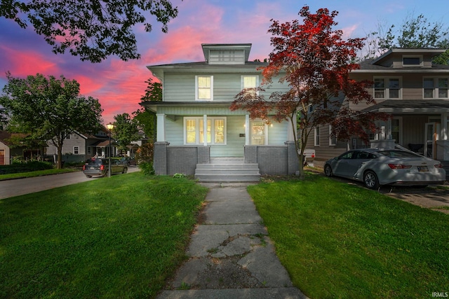 view of front facade featuring a lawn and a porch