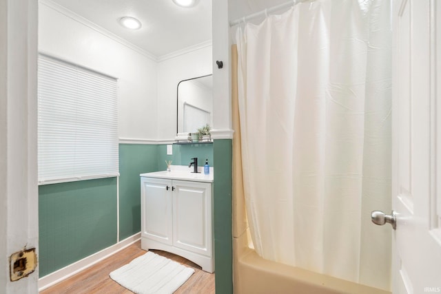 bathroom featuring hardwood / wood-style flooring, vanity, shower / bath combination with curtain, and crown molding